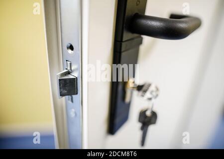 Shallow depth of field (selective focus) image with a metal door lock. Stock Photo
