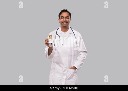 Indian Man Doctor Holding Cough Syrup Isolated Stock Photo