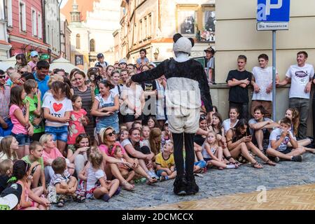 Lublin, Poland - July 26, 2014: Man in panda costume reaching hand to audience at new circus and busking festival Carnaval Sztukmistrzow Stock Photo