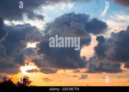 dark dense clouds at sunset in autumn, beautiful dramatic background. Stock Photo