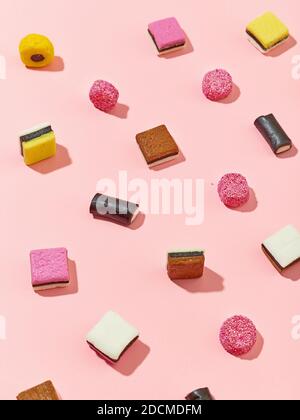 various licorice candies pattern on pink background, selective focus Stock Photo
