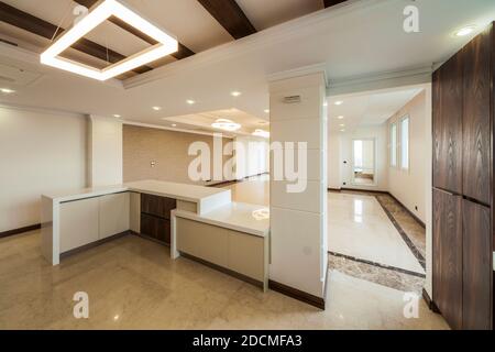 View of the kitchen and living room empty of appliances Stock Photo