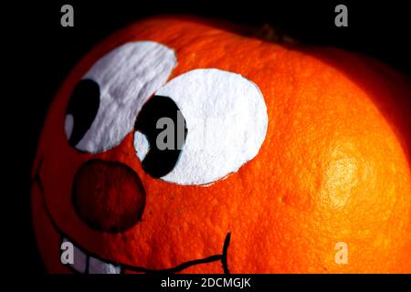 Hand painted pumpkin with grinning face - close up Stock Photo