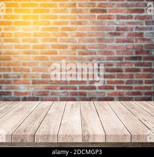 Old wood table with abstract old brick wall background for product display Stock Photo