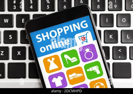 Smartphone With Application For Online Shopping Lying On Computer Keyboard Stock Photo