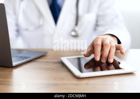 Close up of medical practitioner using his digital tablet Stock Photo