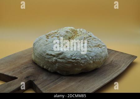 composition of a freshly baked handmade bread placed on an elegant wooden cutting board Stock Photo
