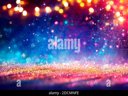 Abstract Defocused Christmas Background - Shiny Golden Glitter With Blurred Lights On Blue Background Stock Photo