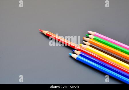 Leadership makes differences shown by color pencils on black background, representing the concept of Standing out from the crowd Stock Photo