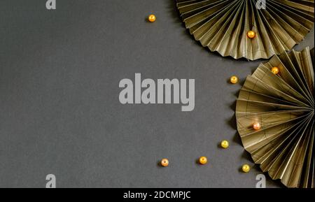 Nice decorative paper fans and beads on the black background. Beautiful design for your purposes. Stock Photo