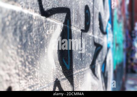 An abstract angle view of a wall covered in graffit in an alley in the city of baltimore maryland. Stock Photo