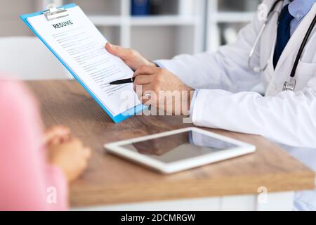Male experienced doctor consulting his female patient Stock Photo