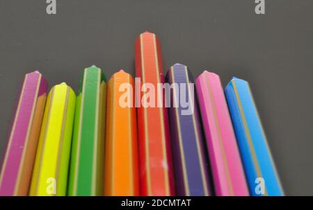 Leadership makes differences shown by color pencils on black background, representing the concept of Standing out from the crowd Stock Photo