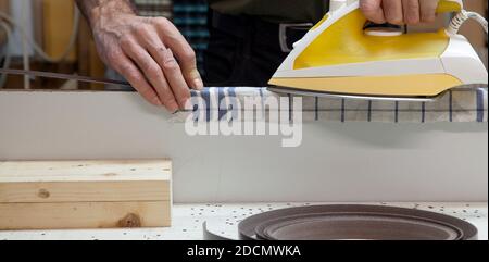 Iron On The Wood Veneer Edge Cabinet Wood With Iron On Edge Banding Applying Wood Veneer Edging With Veneer Edging Tape Furniture Woodworking Stock Photo Alamy