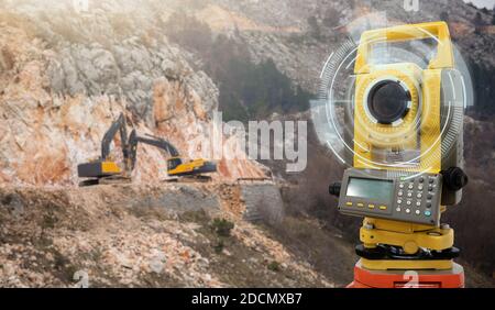 Theodolite, total positioning station, on a background of road construction Stock Photo