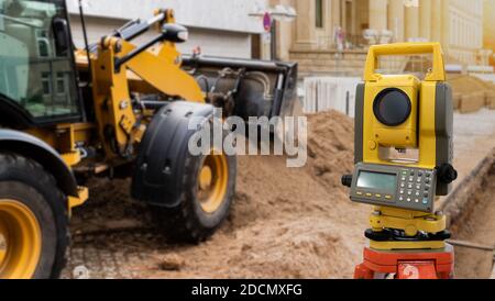 Theodolite, total positioning station, on a background of road construction Stock Photo