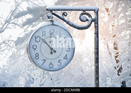 Vintage street clock in winter. New year time Stock Photo