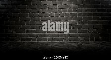 Empty dark brick wall, studio room, for displaying your products. Texture of marble floor and brick wall. Stock Photo