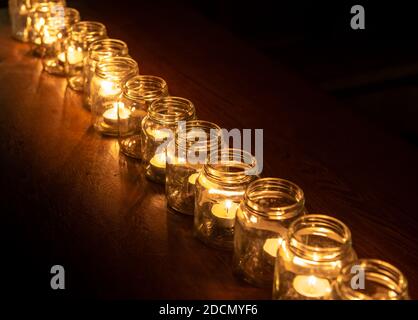 Burning candles in glass jars Stock Photo