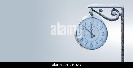 Vintage street clock in winter. New year time Stock Photo