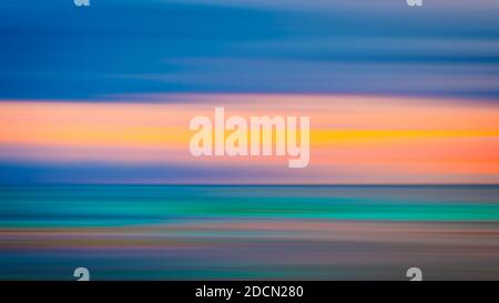 Vivid twilight sunset sky and motion blur of the sea under with long exposure effect. Stock Photo