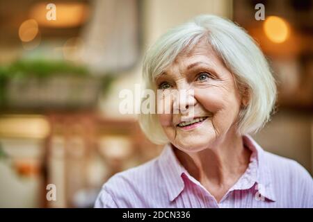 Waist up portrait of beautiful woman looking away while staying outdoors and smiling. Lifestyle concept. Copy space Stock Photo