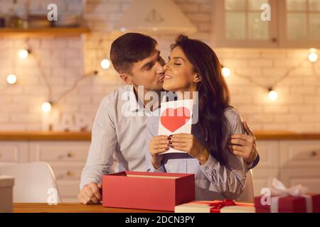 Happy couple celebrating Valentine's Day at home and enjoying spending time together. Stock Photo