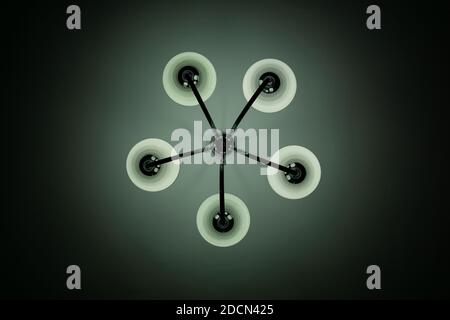 metal chandelier that emits white light on the ceiling Stock Photo