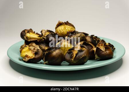 Chestnuts cooked on fire in a plate Stock Photo