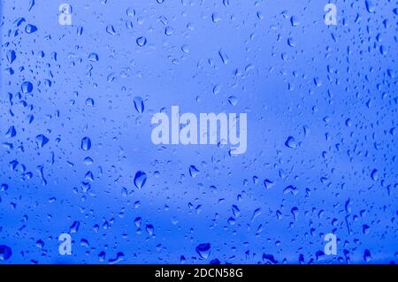 Abstract image of water droplets in the color of the Classic Blue. Selective focus. Horizontal orientation. Blurred background. Stock Photo