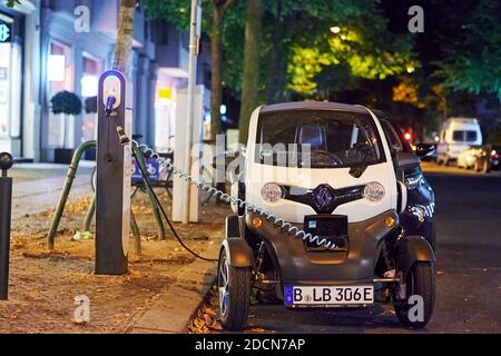 Berlin, Germany - August 16, 2020: View to an electric car that is being charged at a public charging station at night. Stock Photo