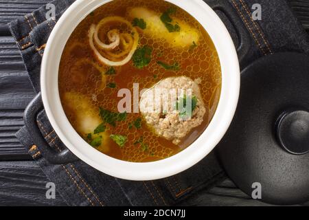 Rindsuppe Traditional Soup From Vienna, Austria close-up in a saucepan on the table. horizontal top view from above Stock Photo