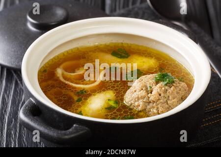 Rindsuppe Traditional Soup From Vienna, Austria close-up in a saucepan on the table. horizontal Stock Photo