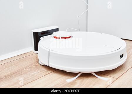 Robot vacuum cleaner return to the charge after cleaning room Modern smart household Stock Photo