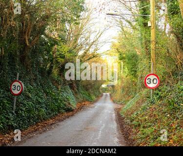 November 2020 - 30 mph speed limit signs on the entrance to the village of Cheddar, in Somerset, UK Stock Photo