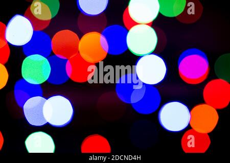 Blurred colored lights garlands. Beautiful Christmas and New Year background. Copy space. Stock Photo