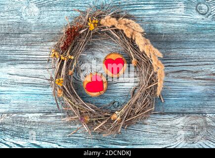 Romantic composition of two hearts and a frame on a wooden background. Stock Photo