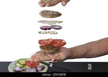 View of homemade vegetarian sandwich  with flying ingredients isolated on white background. Stock Photo
