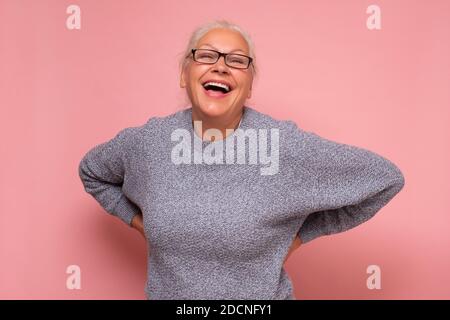 Middle age caucasian woman smiling and laughing hard out loud because funny joke. Studio shot Stock Photo
