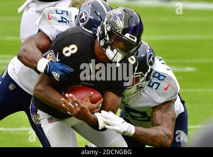 Tennessee Titans Harold Landry III tackles Baltimore Ravens quarterback  Lamar Jackson during overtime of an NFL