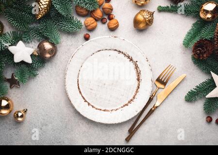 Modern Christmas Table Setting With Empty Plate And Cutlery. Top view, Copy Space For Design Or Text. Toned image Stock Photo