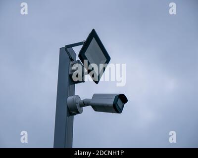 Projector and CCTV camera in gray sky background Stock Photo