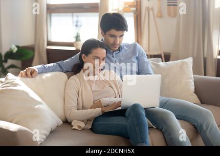 Bonding couple in love having date at home using laptop Stock Photo