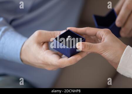 Loving male presenting box with diamond ring to beloved female Stock Photo