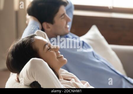 Content young couple resting at home leaning back on sofa Stock Photo