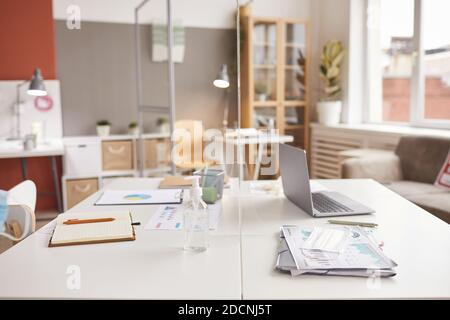 Background image of two office desks separated by glass pane at post pandemic workplace, copy space Stock Photo