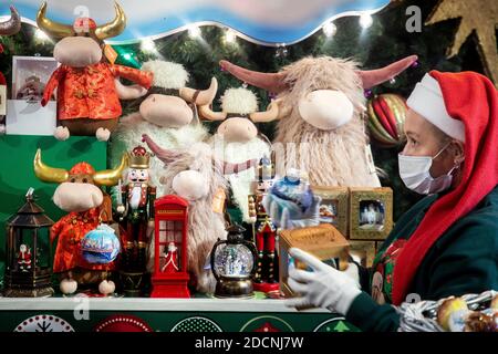 Moscow, Russia. 22nd of November, 2020 Saleswoman wearing protective face mask behind the counter at the New Year Fair in central Moscow store 'GUM' ahead of the upcoming winter holidays, Russia. 2021 year will be the Bull in the Chinese or Eastern calendar Stock Photo