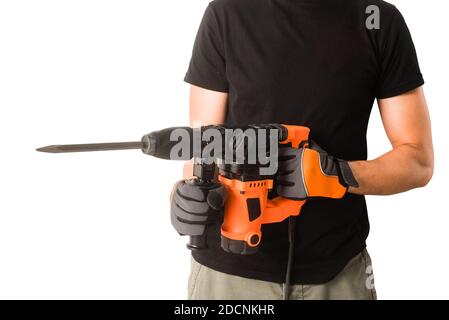 Male hands in protective gloves holding new big electric perforator with long drill and handle at isolated white background Stock Photo