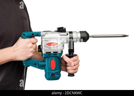 Male hands in protective gloves holding new big electric perforator with long drill and handle at isolated white background Stock Photo
