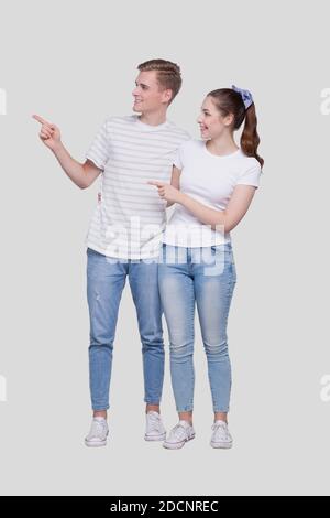 Couple Pointing to Side Standing Isolated. Man and Woman Pointing, Lovers, Friends, Couple Concept Stock Photo